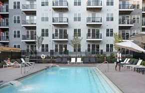 Marlborough apartment for rent - a man standing next to a pool in front of an apartment building
