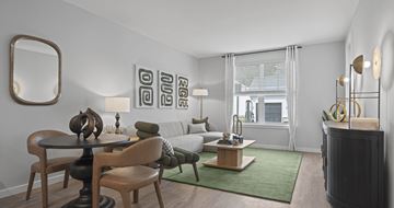 Bolton apartment for rent - A modern living room with a green rug and a wooden table.