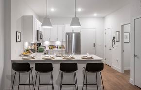 Marlborough apartment for rent - a kitchen with a counter top with four stools