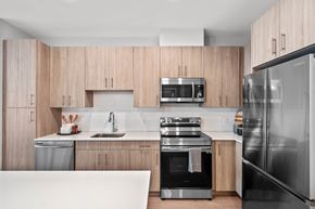 Somerville apartment for rent - a kitchen with wooden cabinets and stainless steel appliances