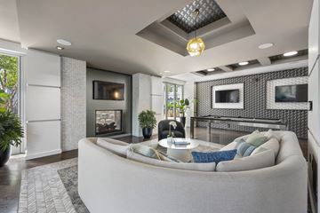 Quincy apartment for rent - A modern living room with a grey couch and a fireplace.