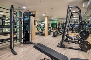 Seattle apartment for rent - a gym with cardio machines and weights on a wooden floor