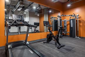 Seattle apartment for rent - A treadmill and a weight machine in a gym.