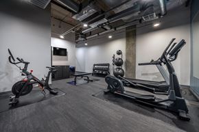 Seattle apartment for rent - A gym with a stationary bike, rowing machine, and other equipment.