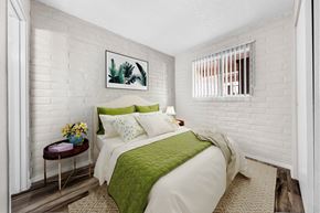Tucson apartment for rent - a bedroom with a bed and a green blanket