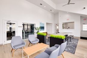 Orlando apartment for rent - A modern office space with grey chairs and a wooden table.