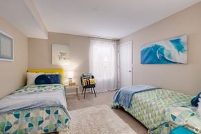 Orlando apartment for rent - A bedroom with two beds and a painting on the wall.