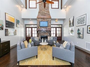 Johns Creek apartment for rent - A living room with a grey couch and a fireplace.