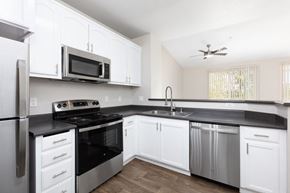 Danville apartment for rent - a kitchen with white cabinets and stainless steel appliances