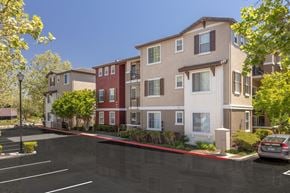 San Ramon apartment for rent - A parking lot in front of a multi-story apartment building.