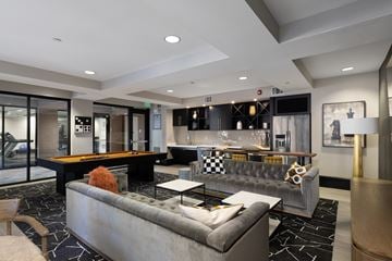 Sunnyvale apartment for rent - A modern living room with a pool table and a grey sofa.