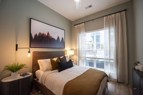 Atlanta apartment for rent - a bedroom with a bed and a large window