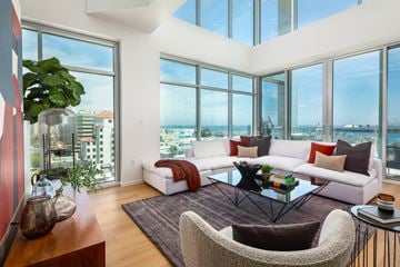 Long Beach apartment for rent - A living room with a white couch and a glass table.