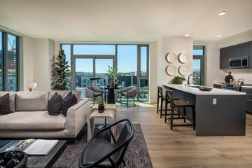Los Angeles apartment for rent - a living room with a couch and a kitchen with a table and chairs