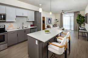 Los Angeles apartment for rent - A modern kitchen with a white island and stainless steel appliances.
