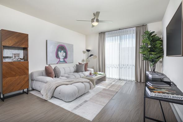 Los Angeles apartment for rent - A living room with a grey sofa and a painting of a woman with purple hair.