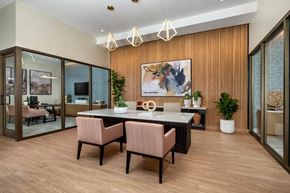 Rancho Cucamonga apartment for rent - A modern dining room with a wooden floor and a large painting on the wall.