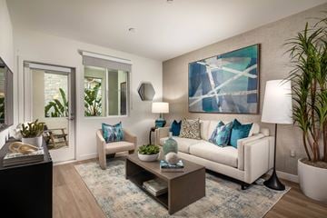 Chula Vista apartment for rent - A living room with a white couch, a coffee table, and a painting on the wall.