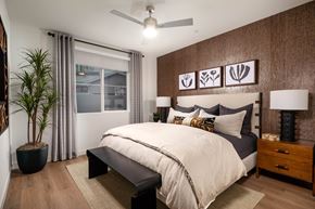 Chula Vista apartment for rent - A bedroom with a large bed and a plant.