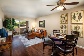 Living room with a dining room table and a ceiling fan