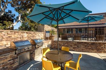 Patio with a table and chairs and an umbrella