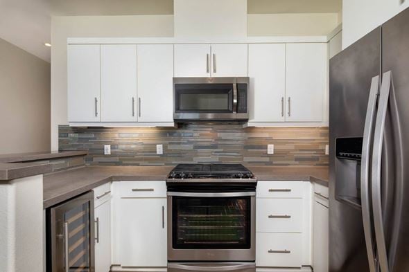 San Diego apartment for rent - Modern kitchen with white cabinets at Avino apartments for rent in Carmel Valley.