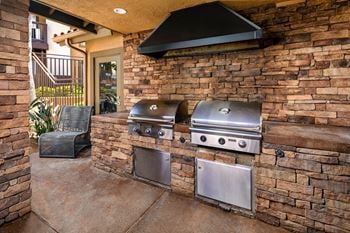 Large outdoor kitchen with two bbqs on a patio