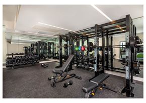 Inglewood apartment for rent - A gym with a variety of equipment including weights and a bench.