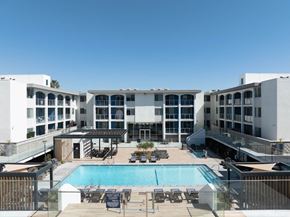 Marina Del Rey apartment for rent - A large white building with a pool in the middle of it.