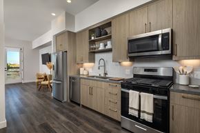 Los Angeles apartment for rent - A modern kitchen with a stainless steel oven and wooden cabinets.