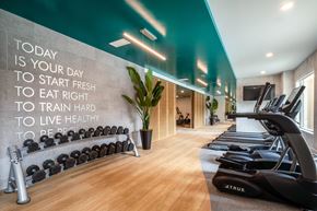 Culver City apartment for rent - A gym with a motivational quote on the wall and exercise equipment.