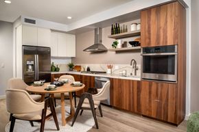 Culver City apartment for rent - A modern kitchen with a wooden table and chairs.