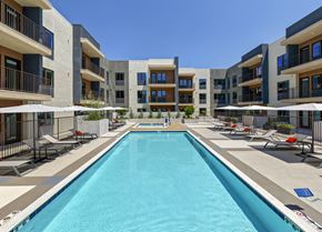 Monrovia apartment for rent - A large swimming pool in front of apartment buildings.