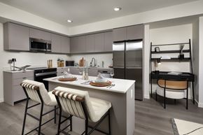 Monrovia apartment for rent - A modern kitchen with a dining table set for two.
