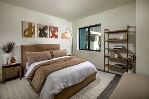 Monrovia apartment for rent - A bedroom with a large bed and a bookshelf.