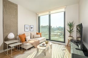 Los Angeles apartment for rent - A living room with a couch, a coffee table, and a television.