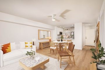 Newport Beach apartment for rent - A living room with a white couch, a coffee table, and a dining table with chairs.