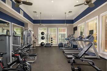 Gym with cardio equipment and windows