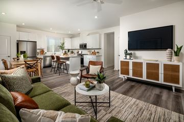 Lancaster apartment for rent - A modern living room with a green sofa and a television on the wall.