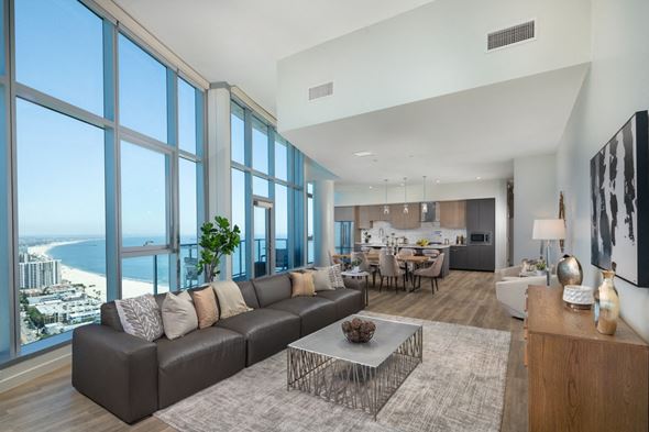 Long Beach apartment for rent - a living room with a couch and a coffee table in front of a wall of windows