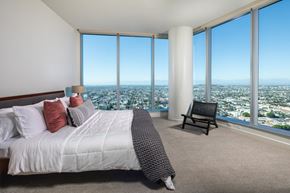 Long Beach apartment for rent - a bedroom with a bed and a chair in front of a window