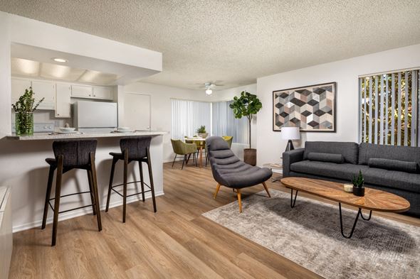 Pomona apartment for rent - A modern living room with a grey sofa and wooden floors.