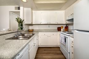 Pomona apartment for rent - A kitchen with white cabinets and appliances.