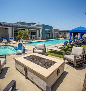 Rancho Cucamonga apartment for rent - a swimming pool with lounge chairs and a fire pit