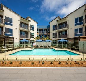 Encinitas apartment for rent - a swimming pool in front of an apartment building