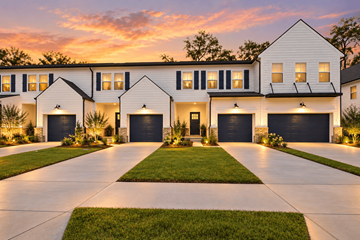 Richmond Hill apartment for rent - A white house with black garage doors is shown.