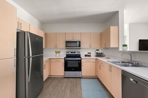 San Diego apartment for rent - A kitchen with a black refrigerator, black microwave, black oven, and black dishwasher.