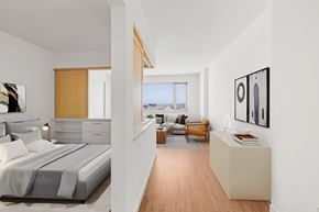 San Francisco apartment for rent - A bedroom with a large bed and a balcony overlooking the city.