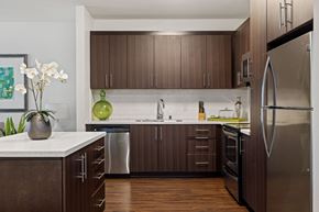 Torrance apartment for rent - A modern kitchen with dark wood cabinets and stainless steel appliances.