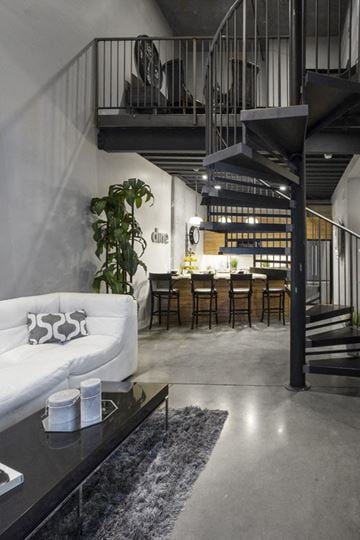Salt Lake City apartment for rent - a living room with a white couch and a staircase